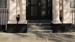 A building with a black door and the sign "BeiRoom" above it. There are numbers '16' on the building's facade. - BeiRoom Hyde Park Apartments (London)