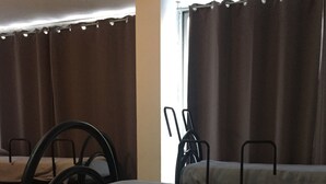 A dining area with a long table, chairs, and a window with curtains. - Scacco Matto (Milan)
