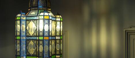 A hanging lantern with intricate patterns and a domed top.