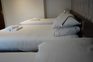 A hotel room with two beds, each with neatly folded towels and pillows. - Marlborough Hotel (Liverpool)