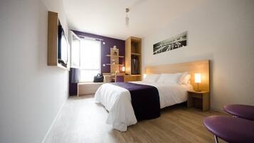 Relax in a stylish room with a large bed, seating area, and city view.