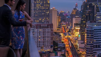 A cityscape with illuminated buildings and a busy street.