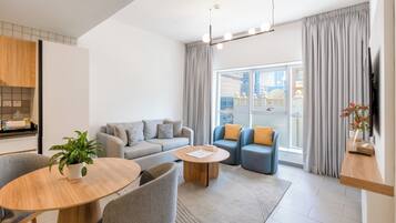 Executive Apartment, 1 Bedroom | Living area | 50-inch LCD TV with digital channels, TV