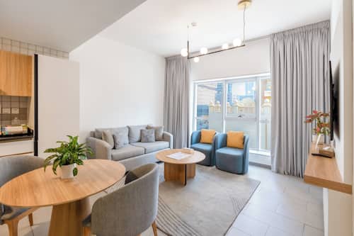 Executive Apartment, 1 Bedroom | Living area | 50-inch LCD TV with digital channels, TV