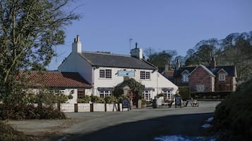 Step into this charming pub with a traditional facade and a warm entrance.