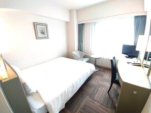 A hotel room with a bed, a desk, a chair, a small table, a television, and a picture on the wall. - Grand Central Hotel (Tokyo)