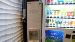 A vending machine with a water dispenser and a selection of beverages. - Grand Central Hotel (Tokyo)