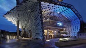 A modern building with a unique geometric exterior and a covered outdoor area. - IZE Seminyak by LifestyleRetreats (Seminyak)