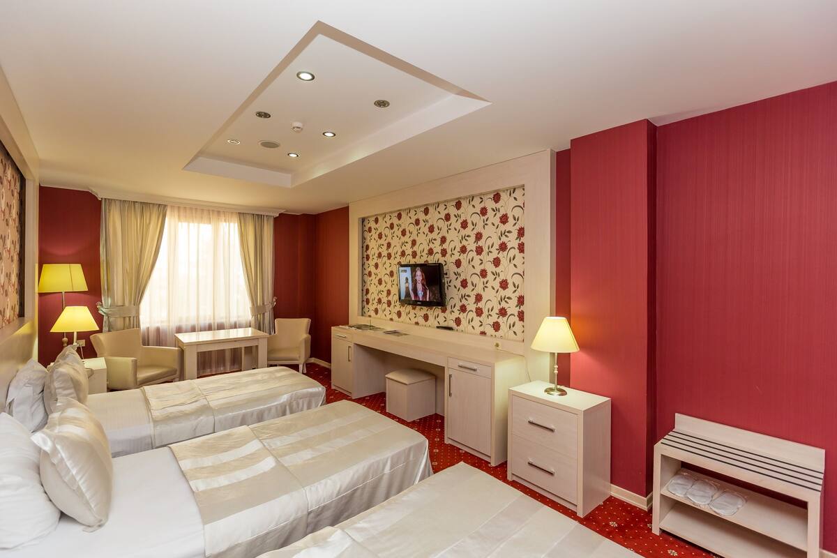 Standard Triple Room | Minibar, in-room safe, desk, iron/ironing board (on request)