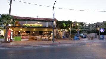 Una cafetería con terraza y escaparate visible.