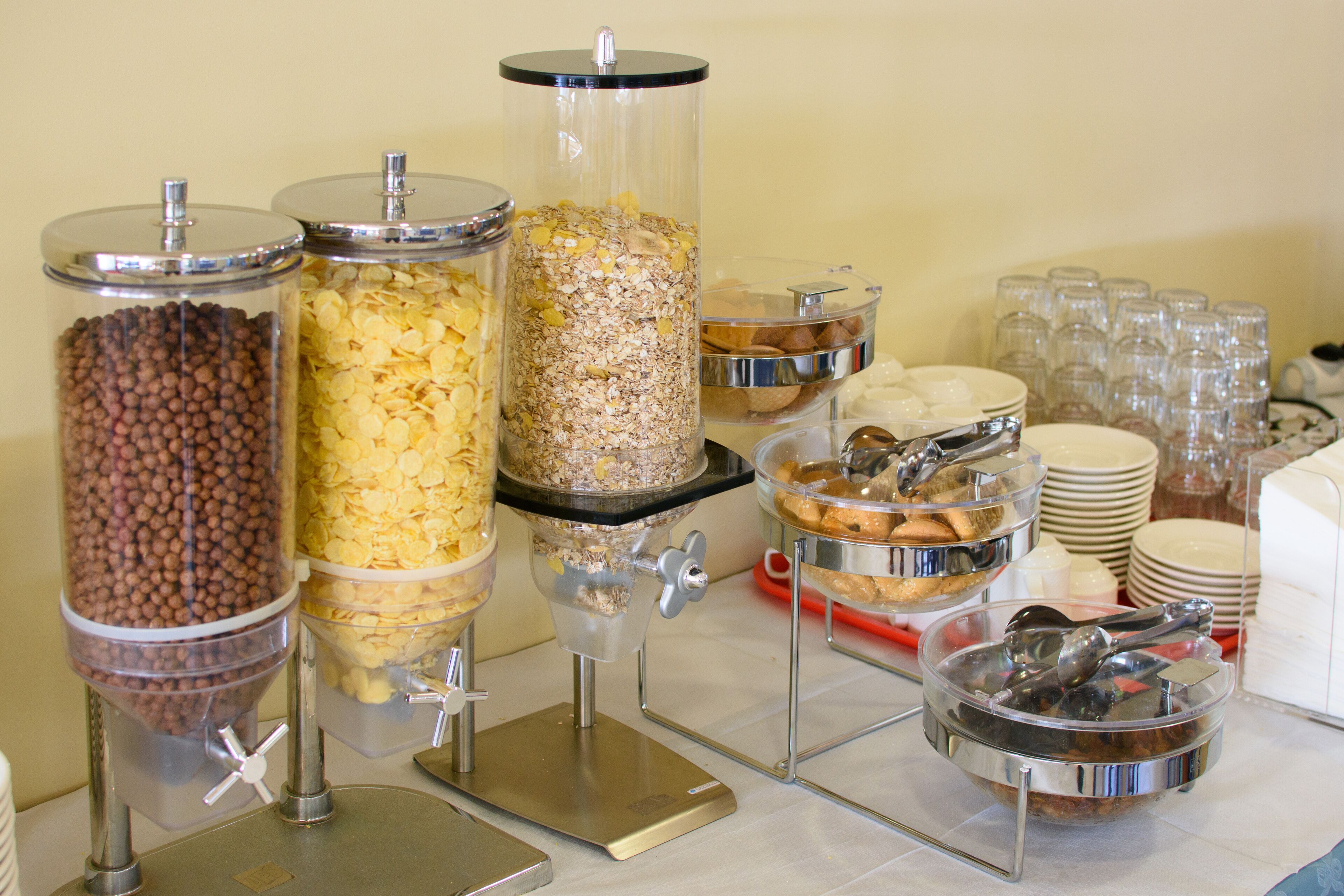 A buffet setup with various food dispensers and serving dishes.