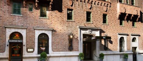 A brick building with a storefront labeled "Salvation Taco."