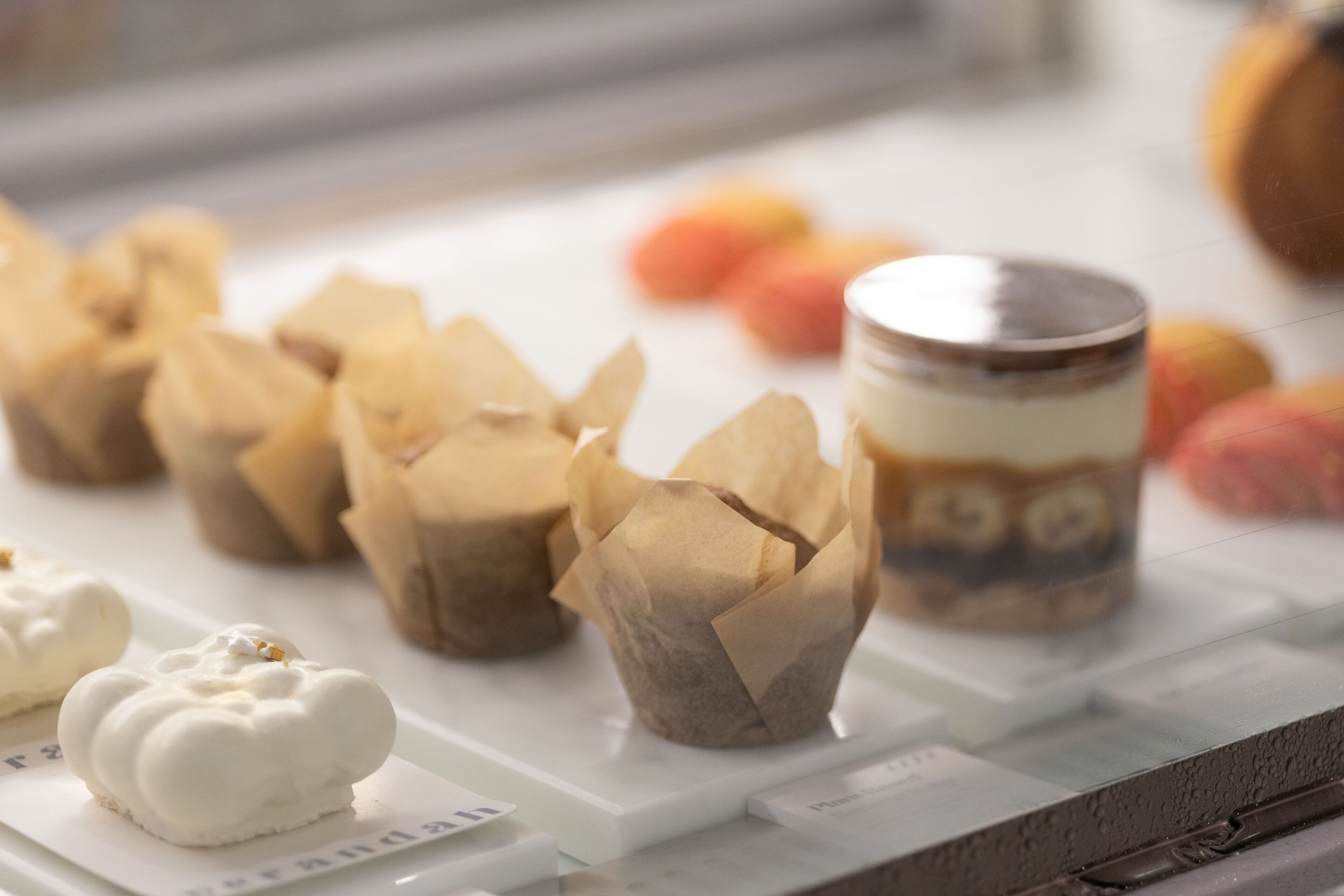 A display of pastries and a jar on a white surface.