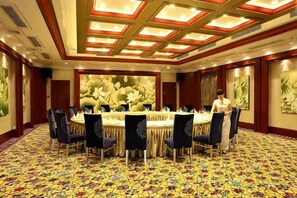 A conference room with a large oval table, multiple chairs, and a patterned carpet. - Yucheng Hotel (Suzhou)