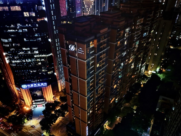 A high-rise building with illuminated signage, including a prominent 'D' logo and 'China Minsheng Bank' text.