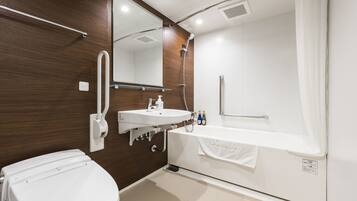 A modern bathroom with a toilet, sink, and bathtub.