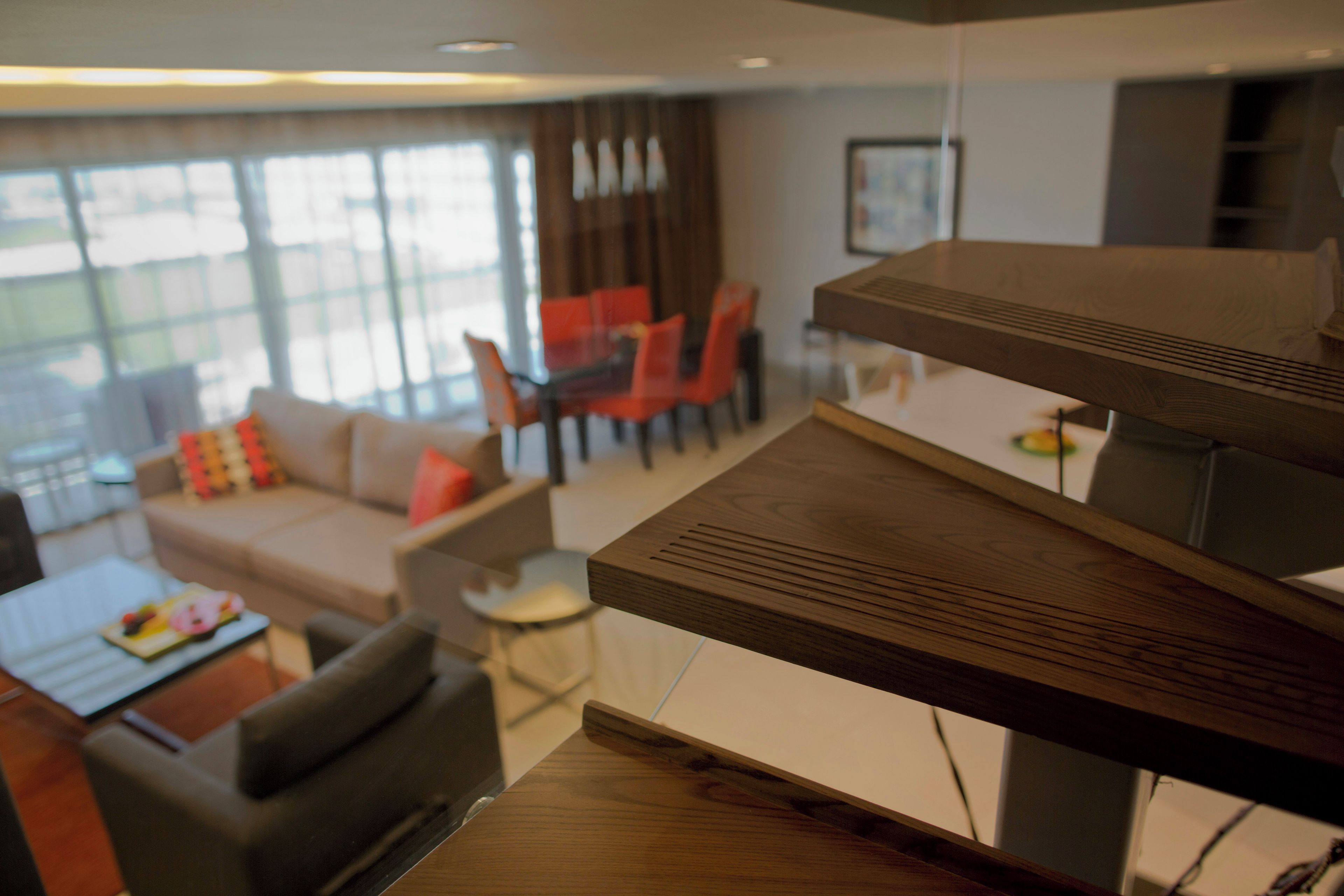 A modern living room with a sofa, chairs, and a coffee table.