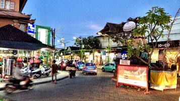 A street scene with shops, a signboard, and a traditional building.