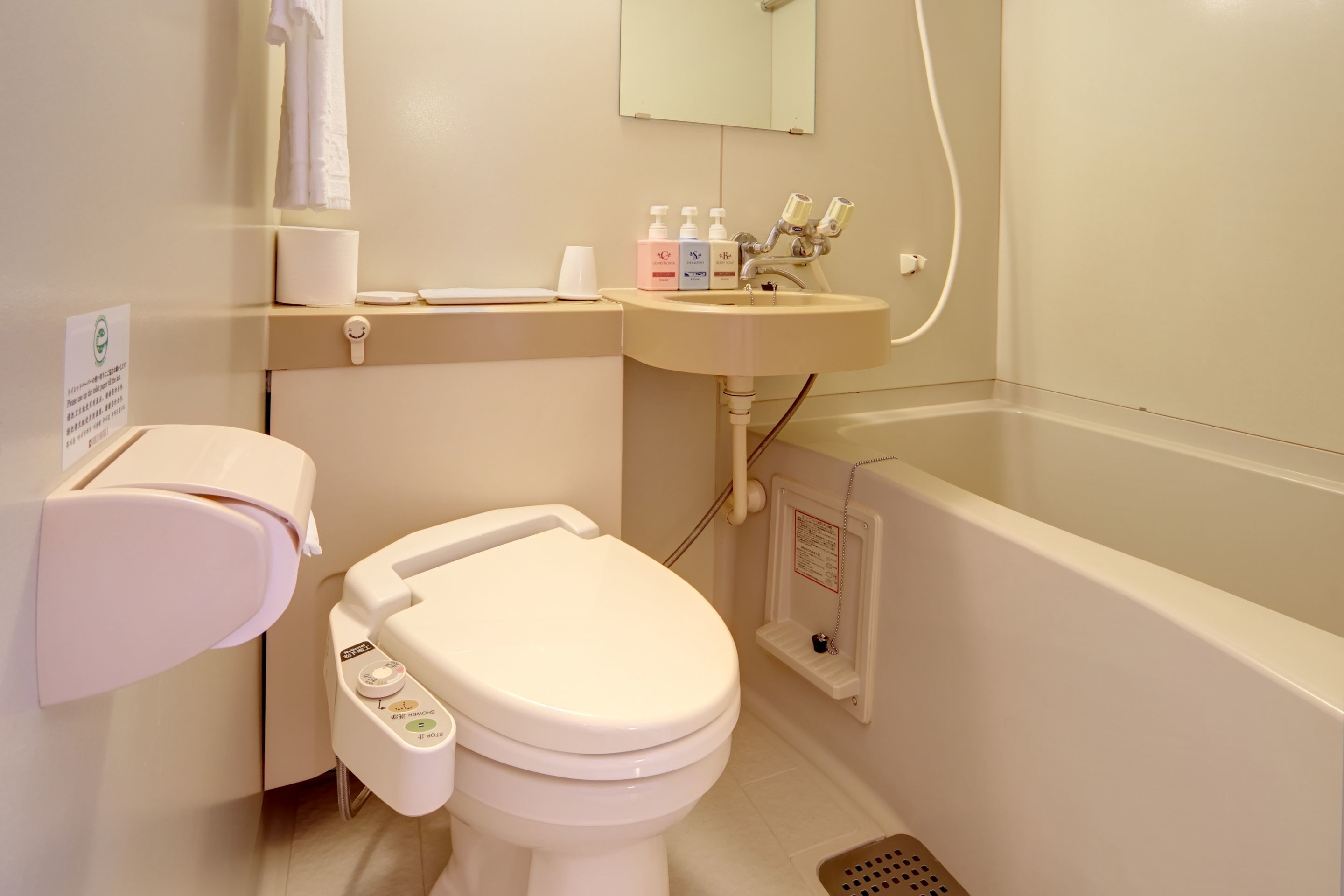 A modern bathroom with a toilet, sink, and bathtub.