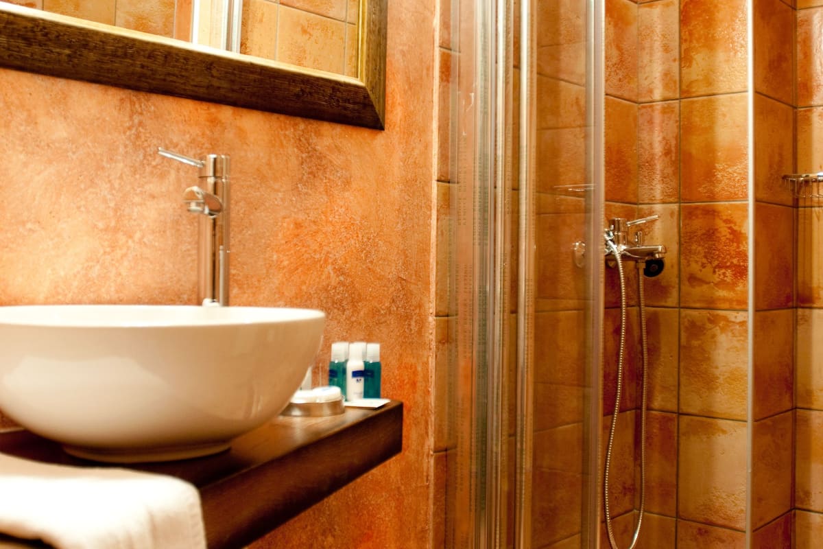 shower, hair dryer, slippers, towels