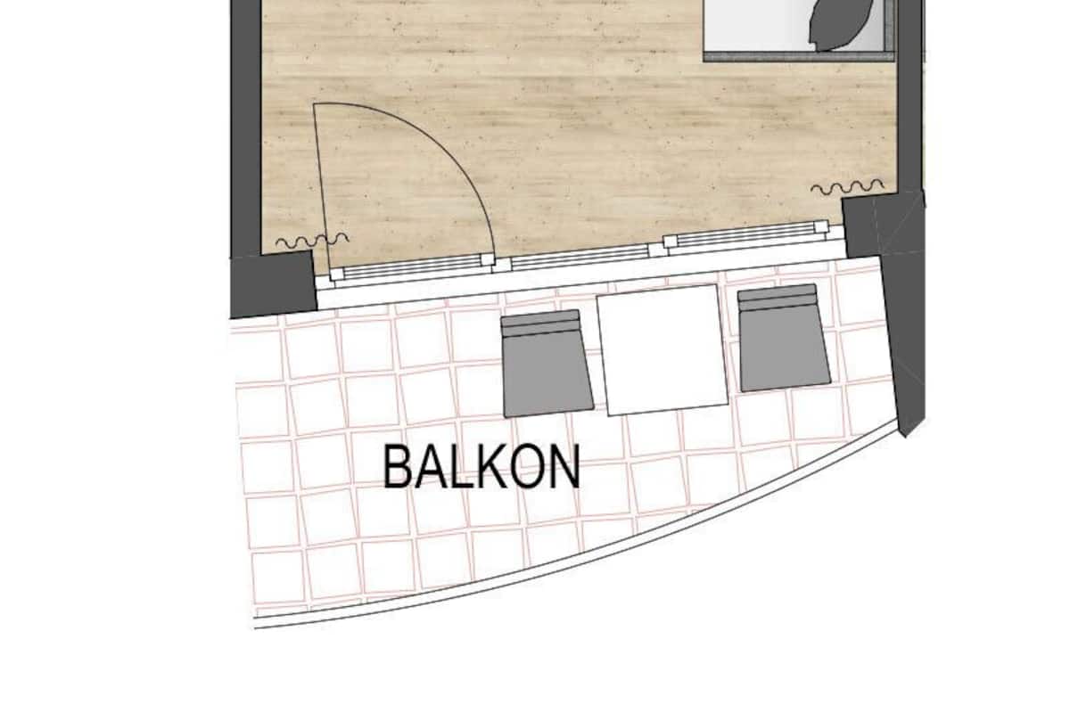 Ein Grundriss mit Wohnzimmer, Kochnische, Badezimmer und Balkon.