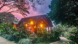 A rustic building with a sign indicating a reception, restaurant, and rooms.