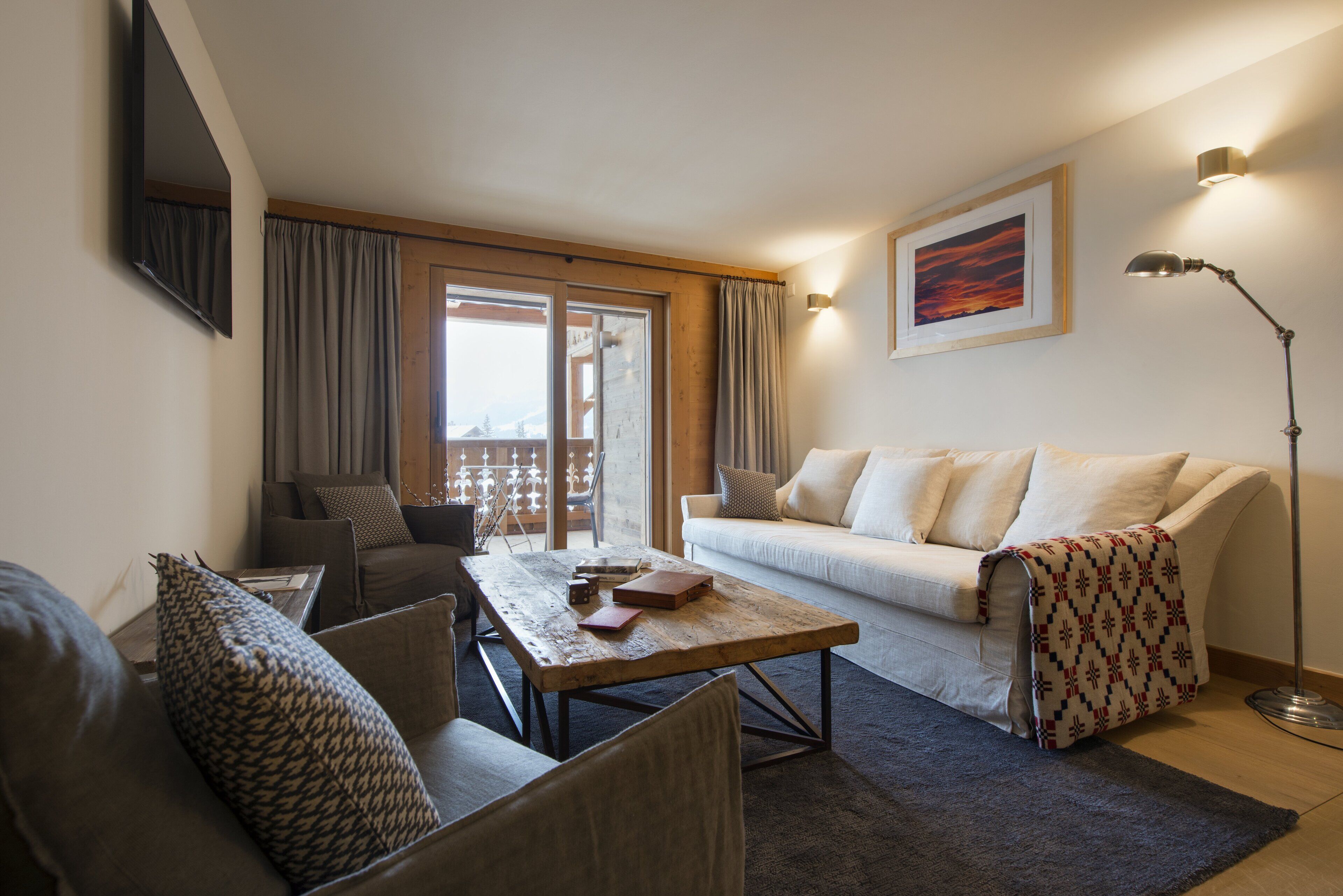A modern living room with a sofa, a coffee table, and a floor lamp.