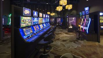Experience the excitement of gaming with a variety of slot machines and modern lighting.