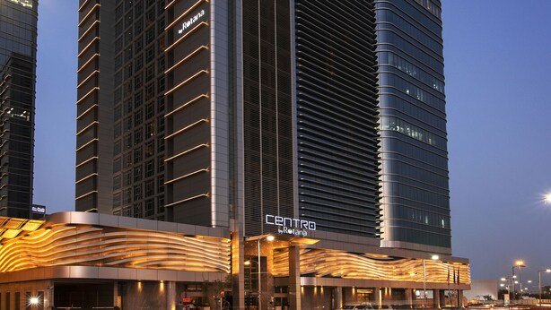 A modern hotel with a prominent 'CENTRO by Rotana' sign, featuring a sleek, curved facade and a series of balconies. - Centro Capital Centre (Abu Dhabi)