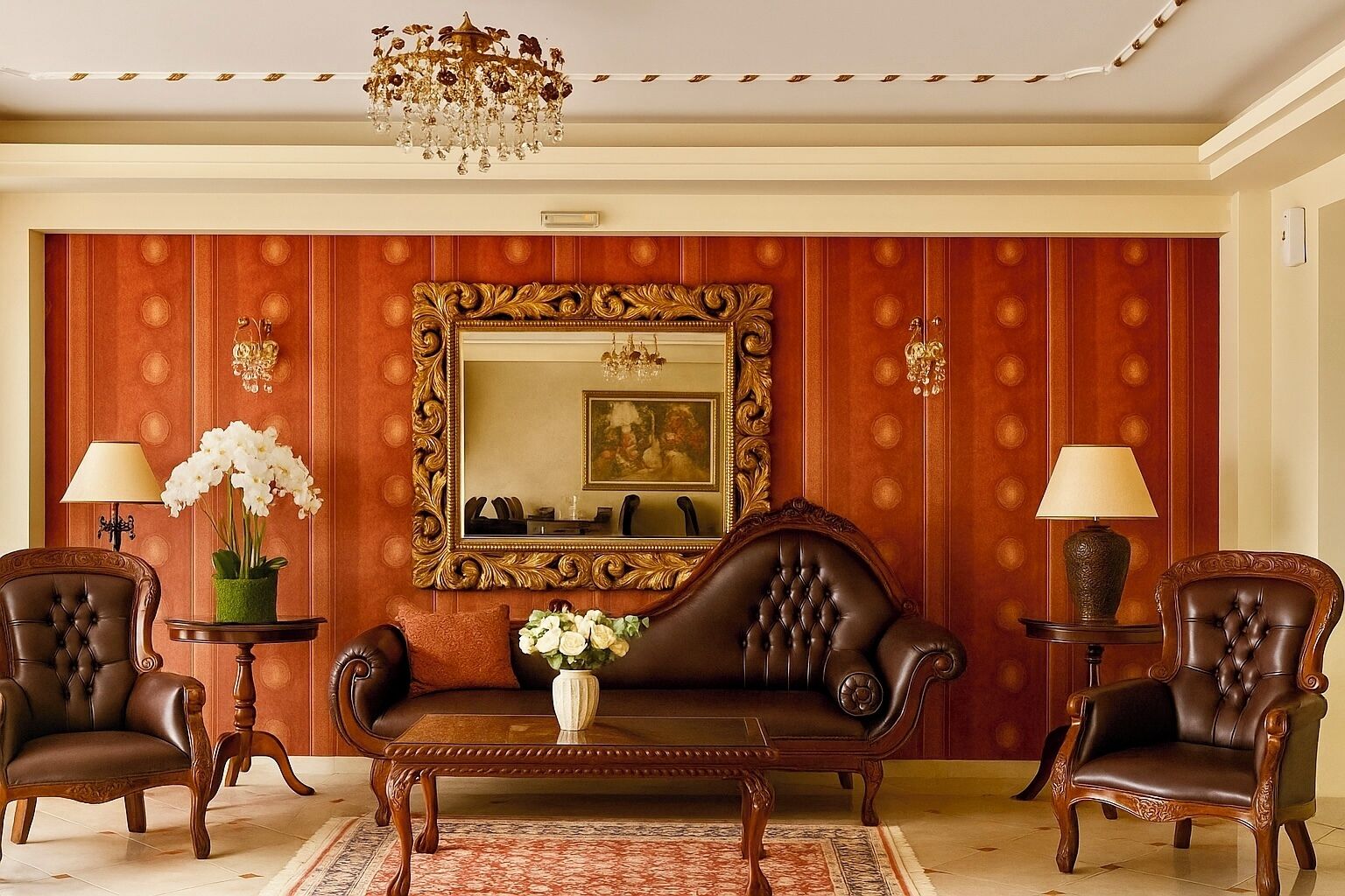 A formal sitting room with a large mirror, two leather chairs, a sofa, a coffee table, and a chandelier.
