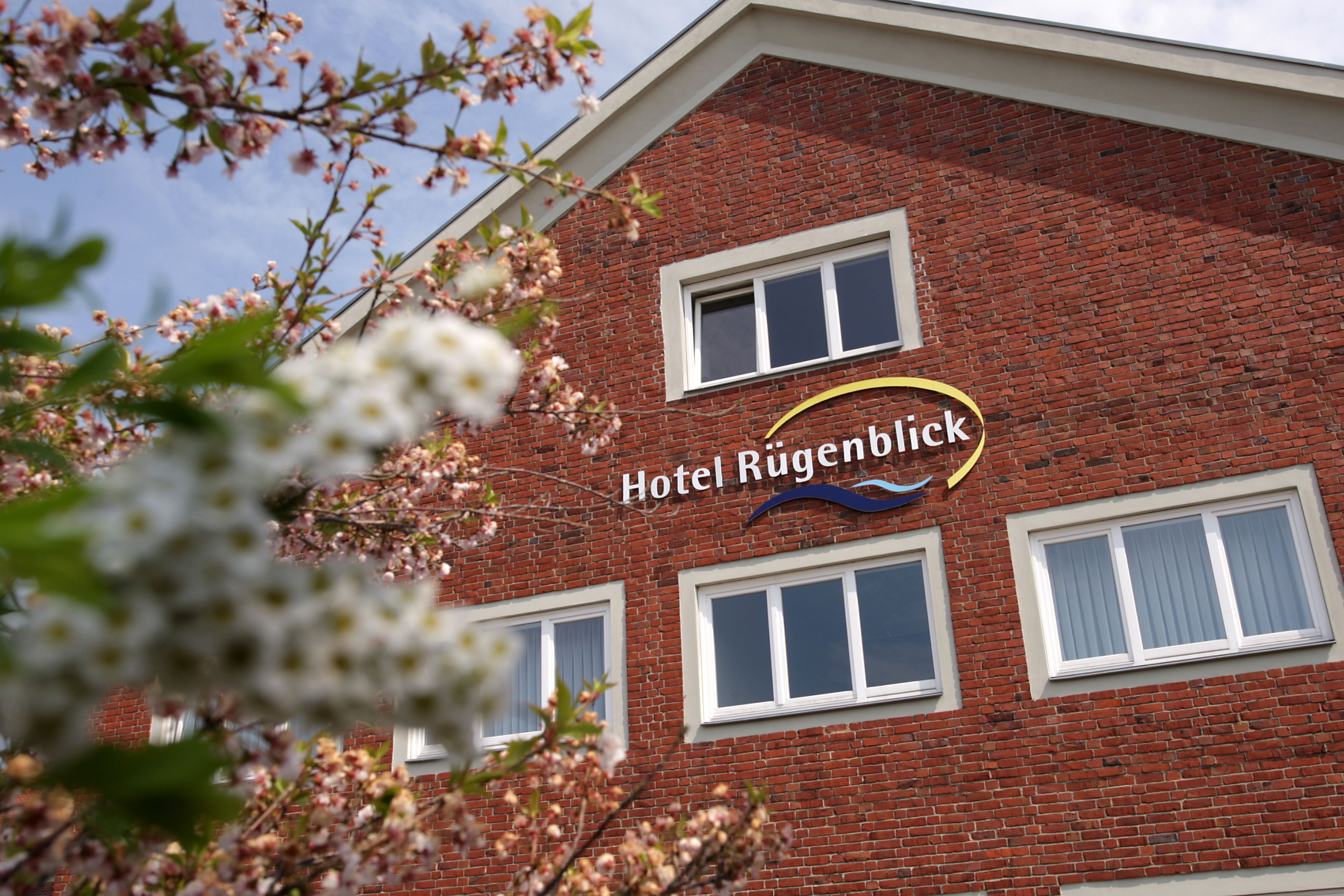 A hotel named "Hotel Rügenblick" with a brick facade and multiple windows.