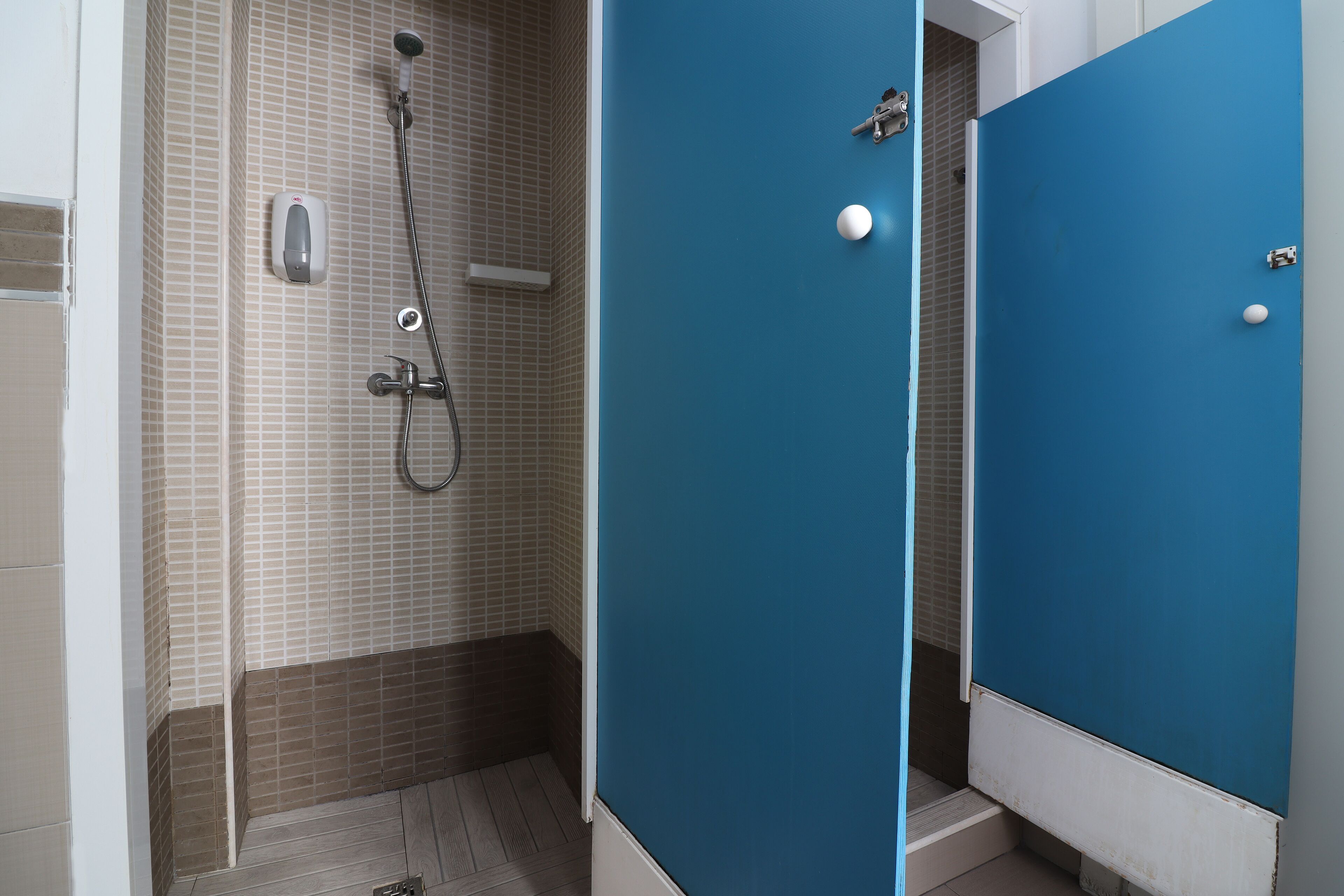 A bathroom with a shower, a toilet, and a sink.
