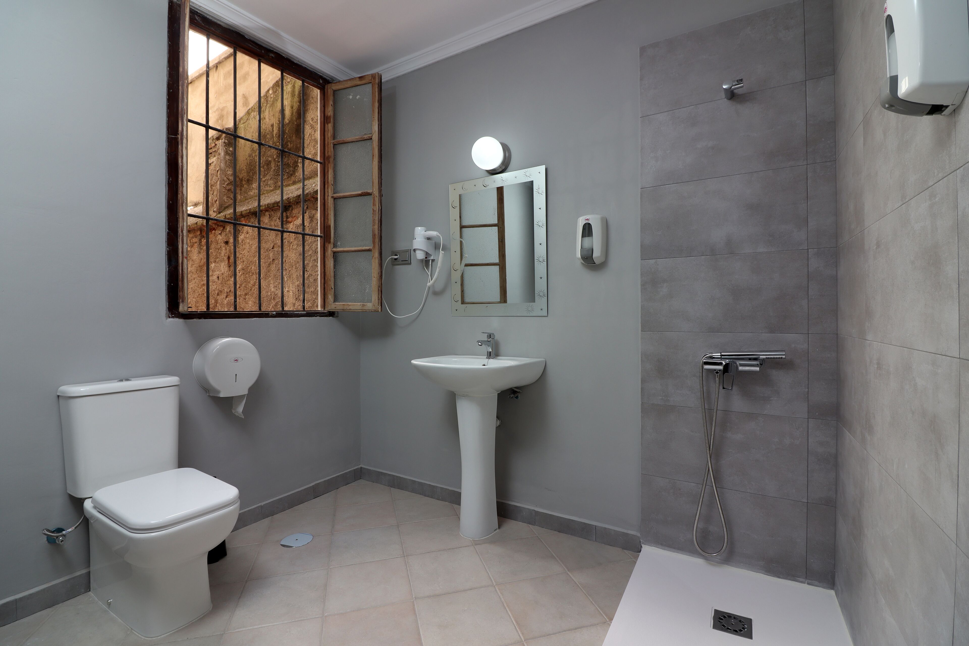 A bathroom with a toilet, sink, and shower.