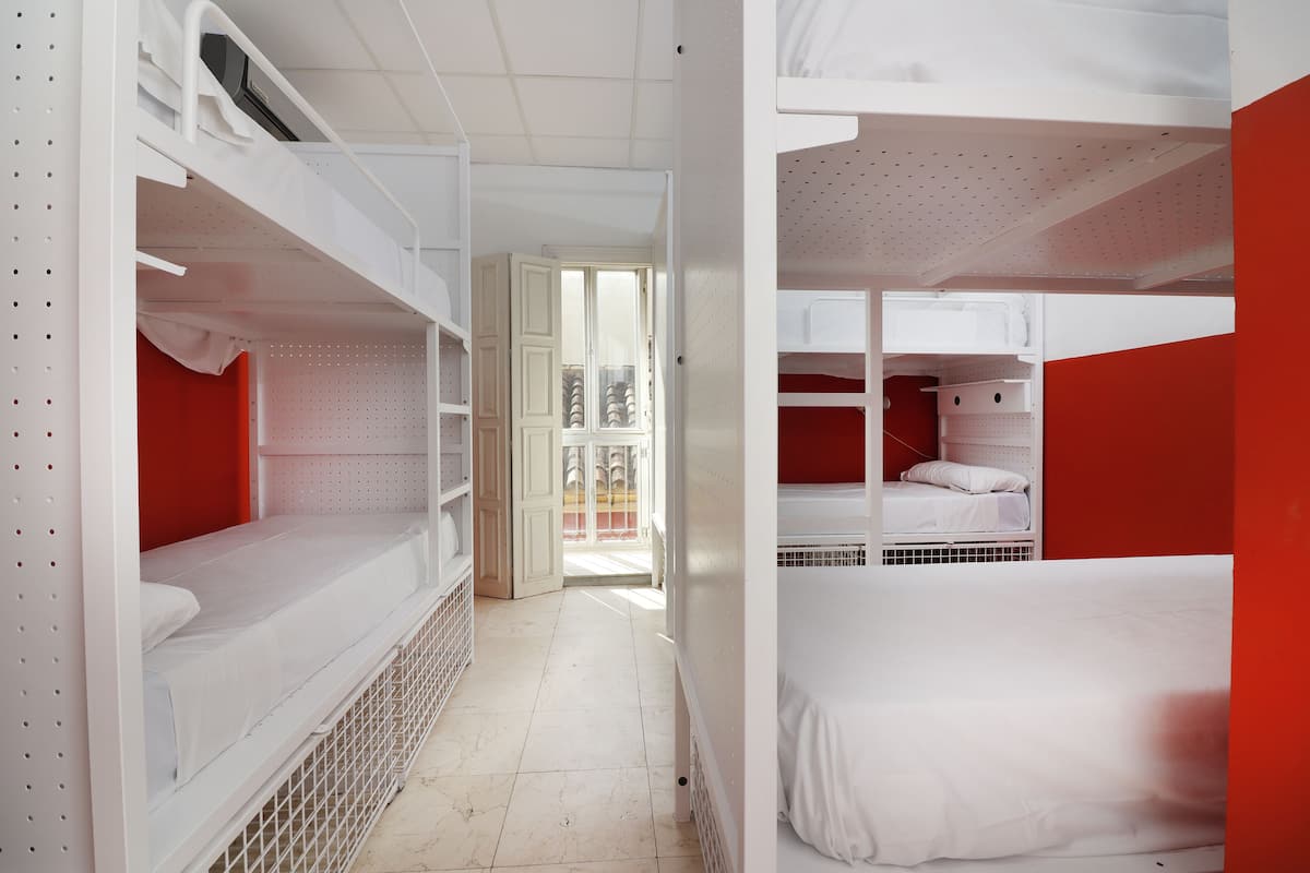 A bunk bed room with a door leading to a balcony.