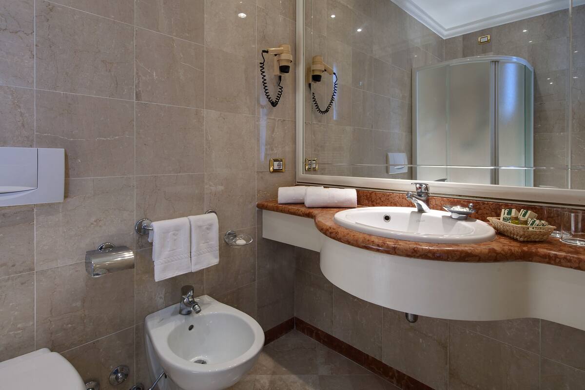 classic double room | bathroom | hair dryer, bidet, towels
