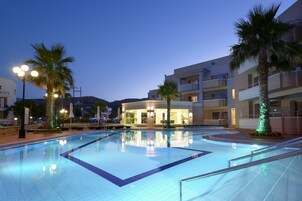 Una piscina al aire libre, sombrillas, tumbonas