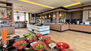 A modern hotel lobby with a reception desk, buffet area, and various amenities. - Ramada by Wyndham Tekirdag (Tekirdag)