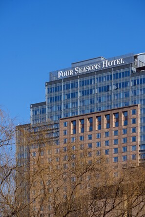 A hotel building with a clear sky. The name "Four Seasons Hotel" is visible on the top. - Four Seasons Hotel Beijing (Beijing)