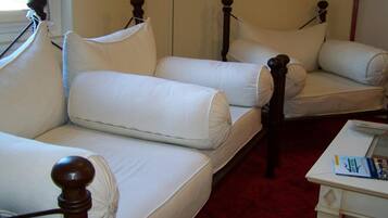 A room with a bed, a small table, and a window.