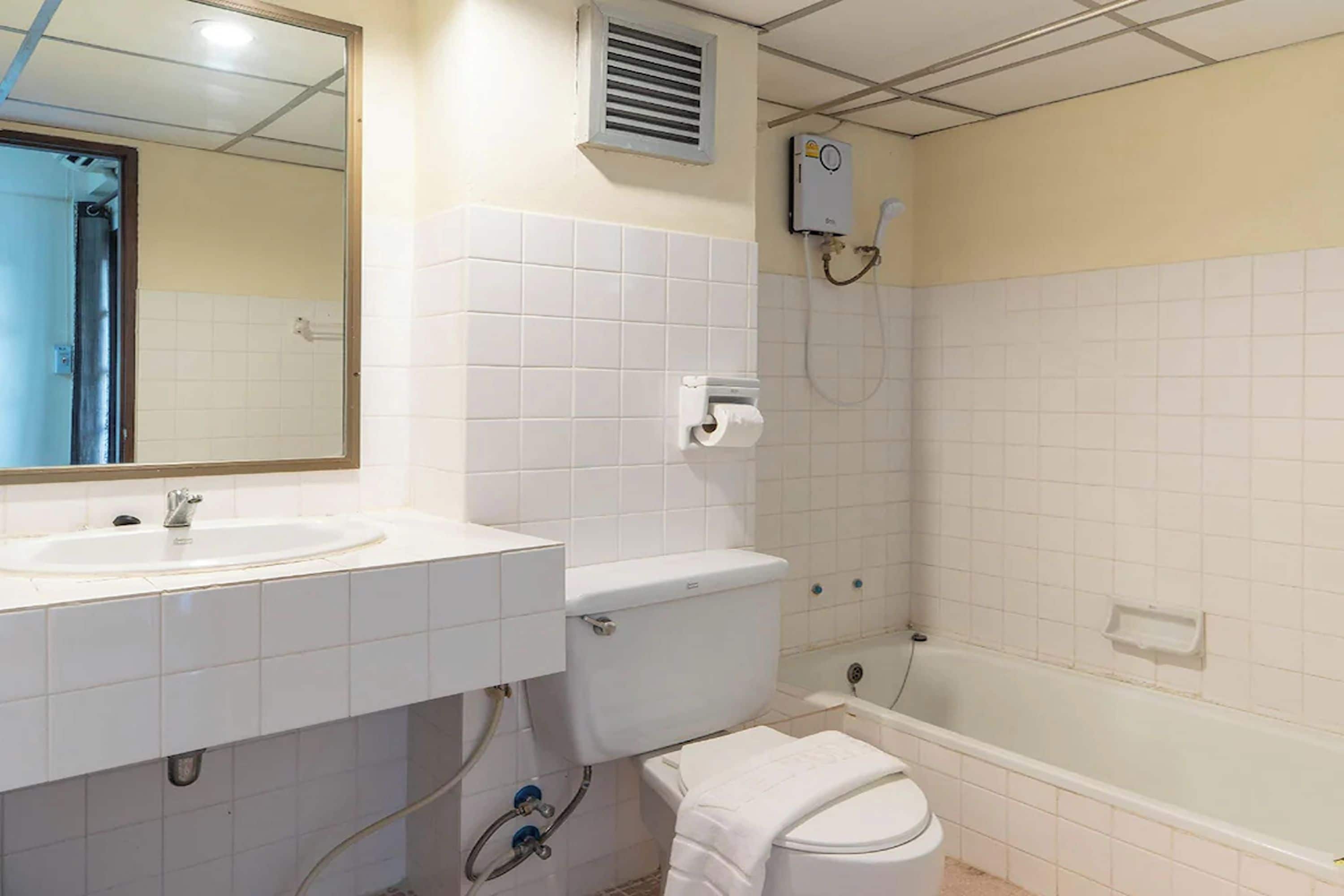 A bathroom with a sink, toilet, and bathtub.