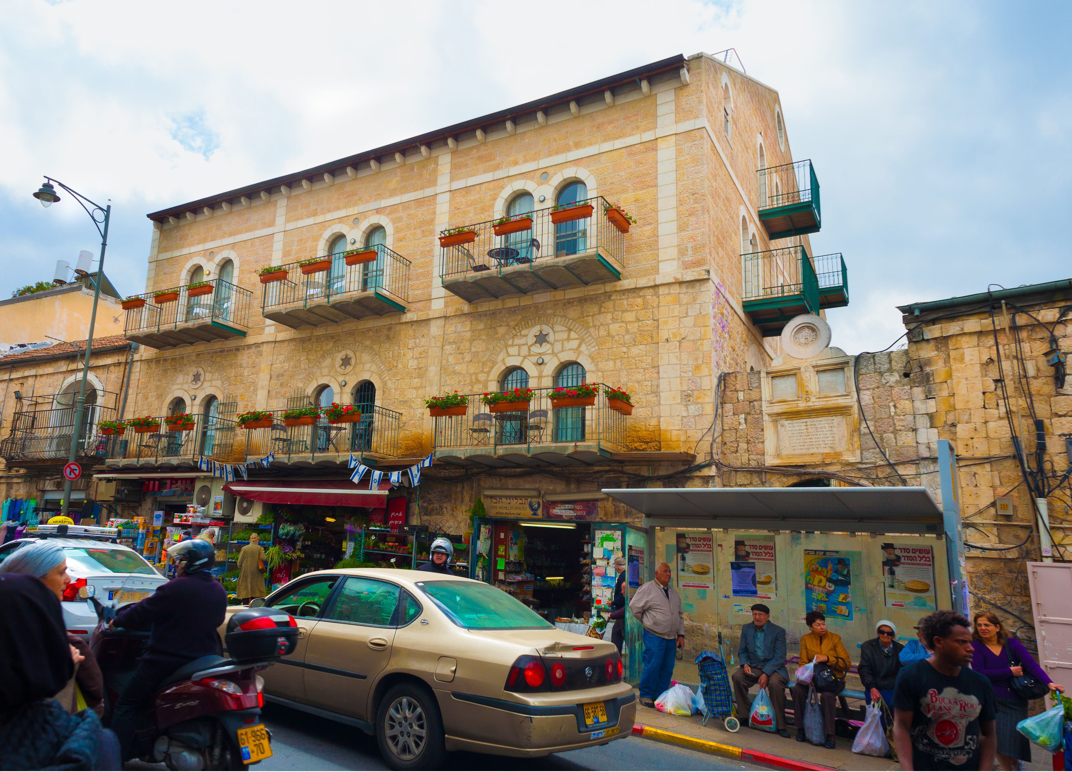 A historic building with multiple balconies, some with plants.