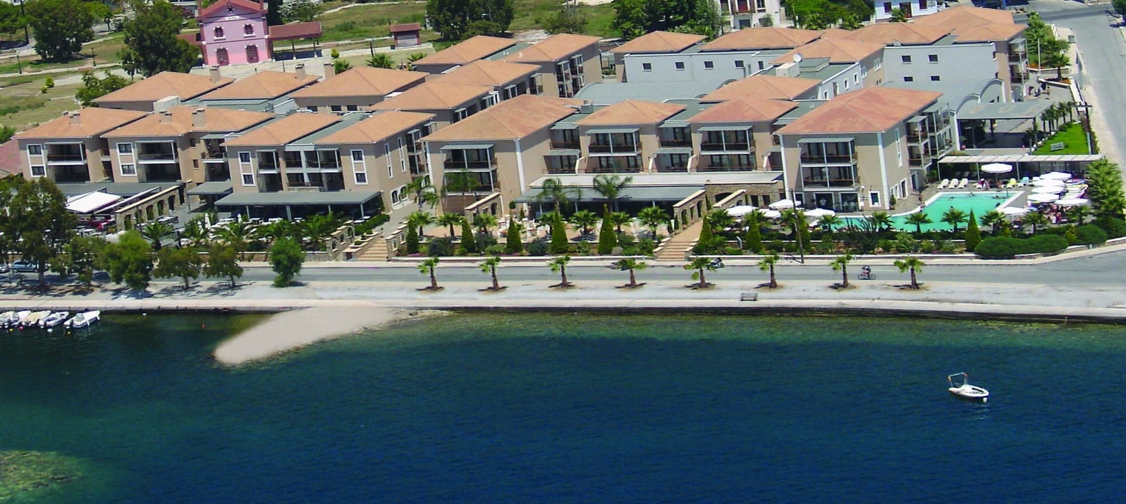A coastal hotel with multiple buildings, a swimming pool, and a marina.