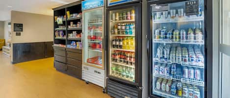 A row of beverage vending machines with various drink options.