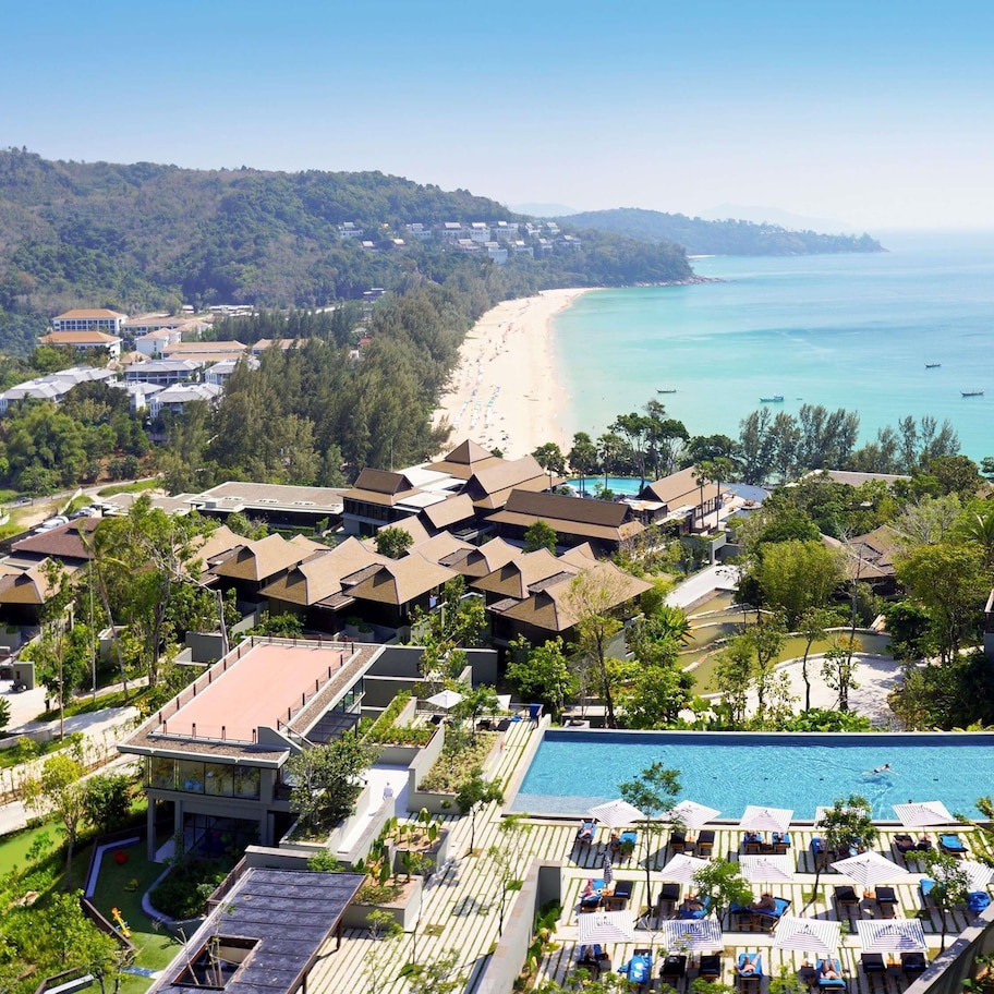 A resort with a swimming pool, beach, and ocean views.
