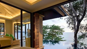 A luxurious room with a large bathtub filled with rose petals, a sofa, and a view of the sea. - Pullman Phuket Arcadia Naithon Beach (Sa Khu)