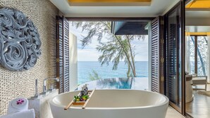 A modern bathroom with a freestanding bathtub, a large mirror, and a view of the ocean. - Pullman Phuket Arcadia Naithon Beach (Sa Khu)