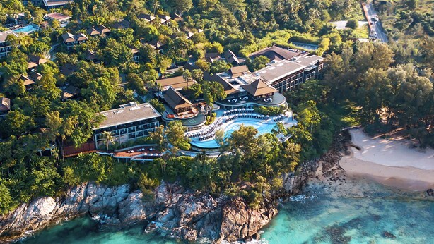 An aerial view of a resort with multiple buildings, a swimming pool, and a beach. - Pullman Phuket Arcadia Naithon Beach (Sa Khu)