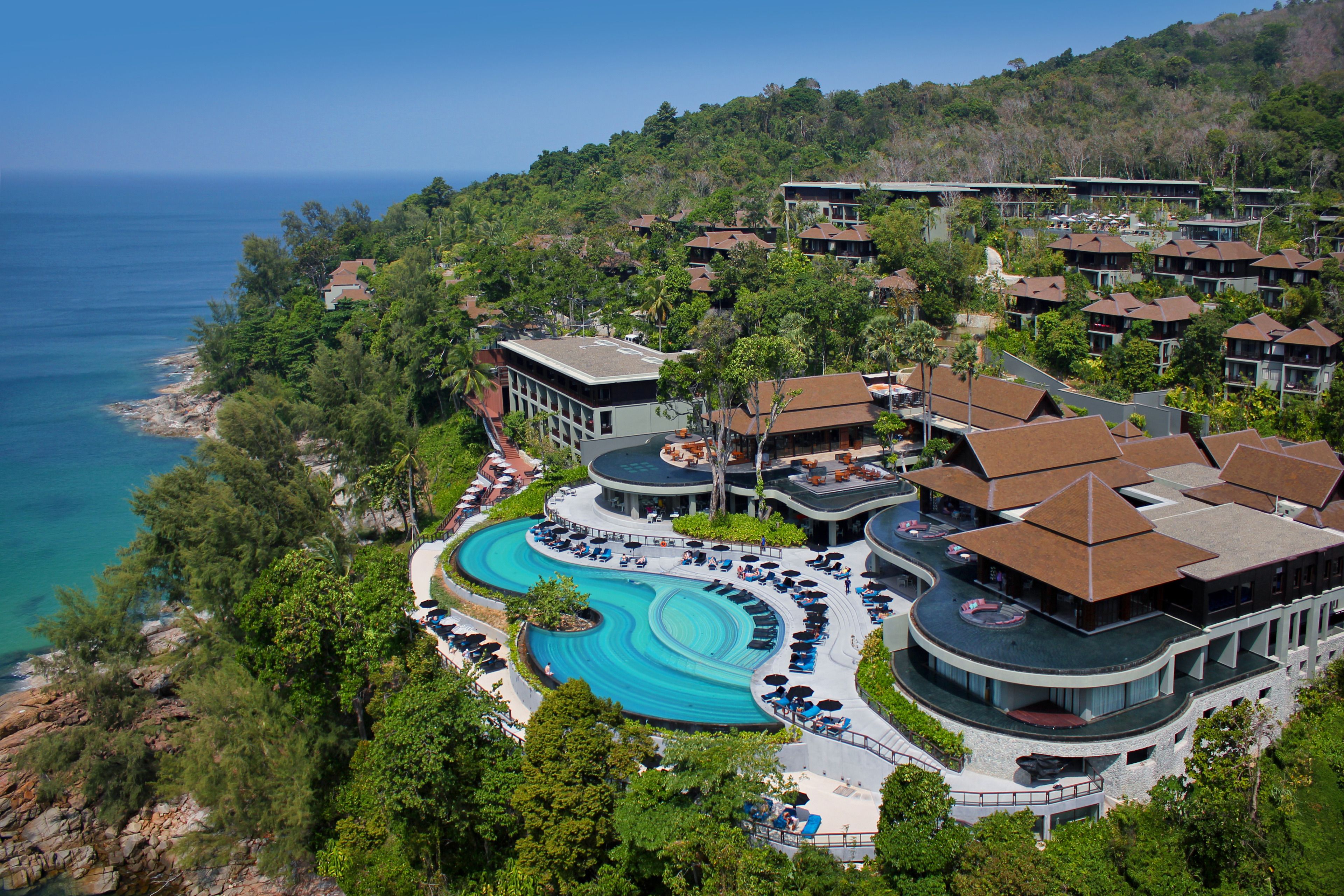 A resort with a pool, beachfront, and multiple buildings.