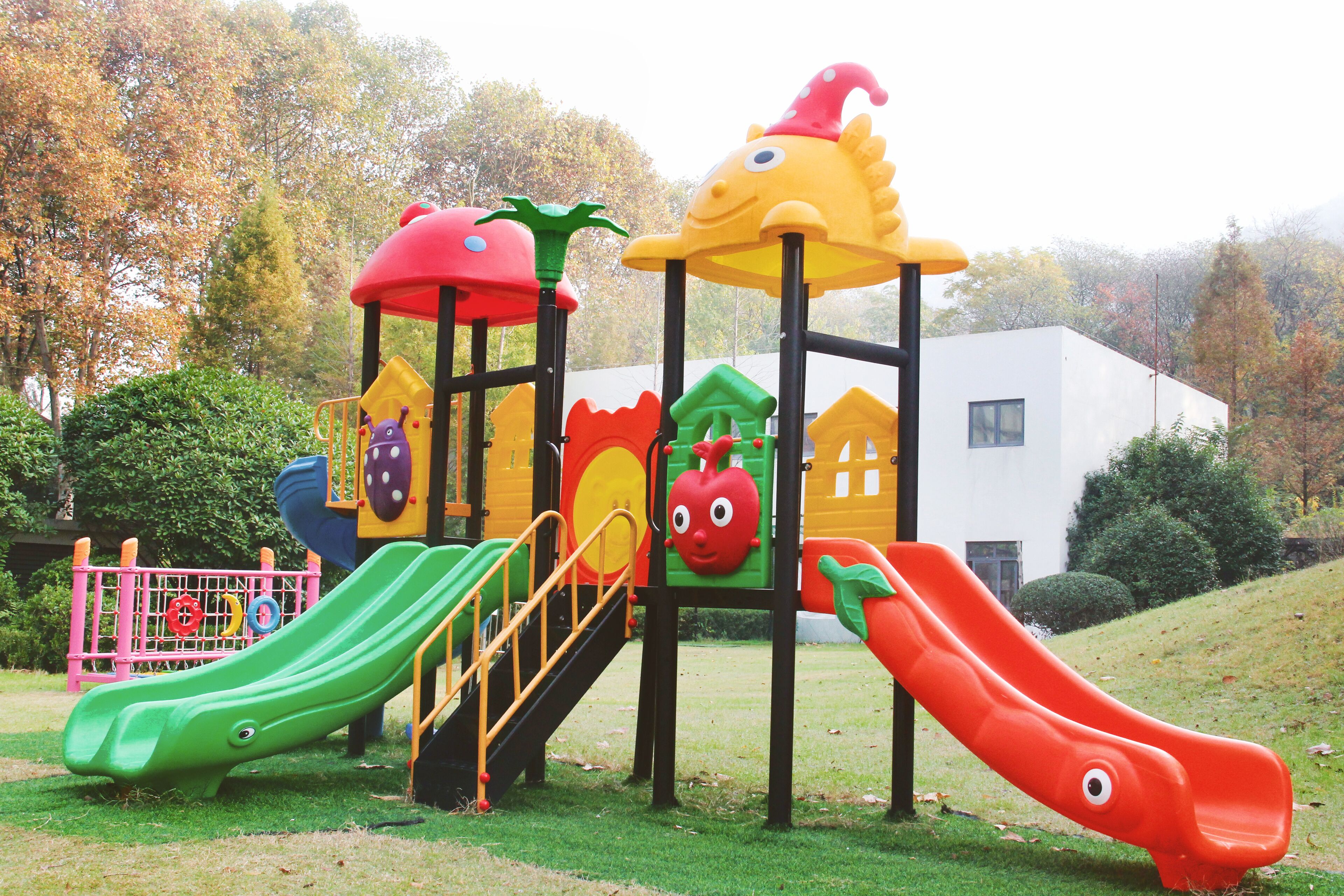A playground with multiple slides and climbing structures.