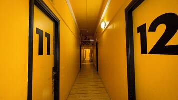 A hallway with doors numbered 11 and 12, leading to a common area.